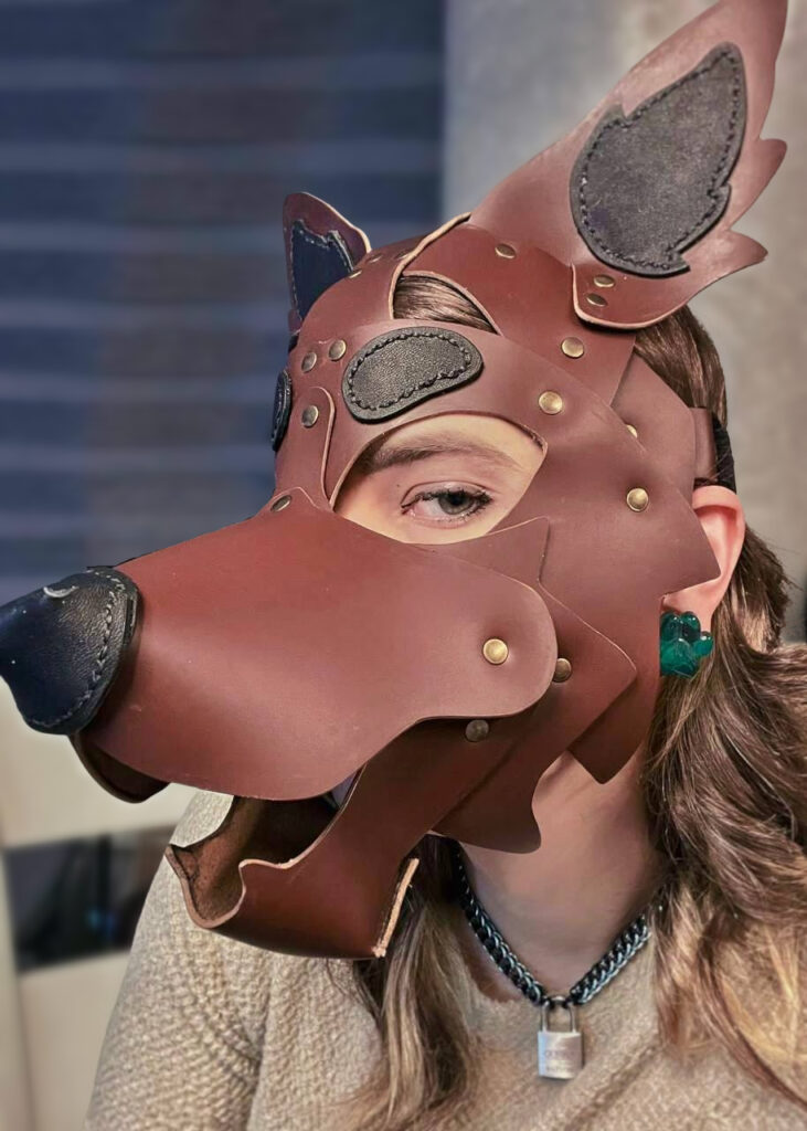 A brown leather puphood being worn by a women in a taupe sweater.